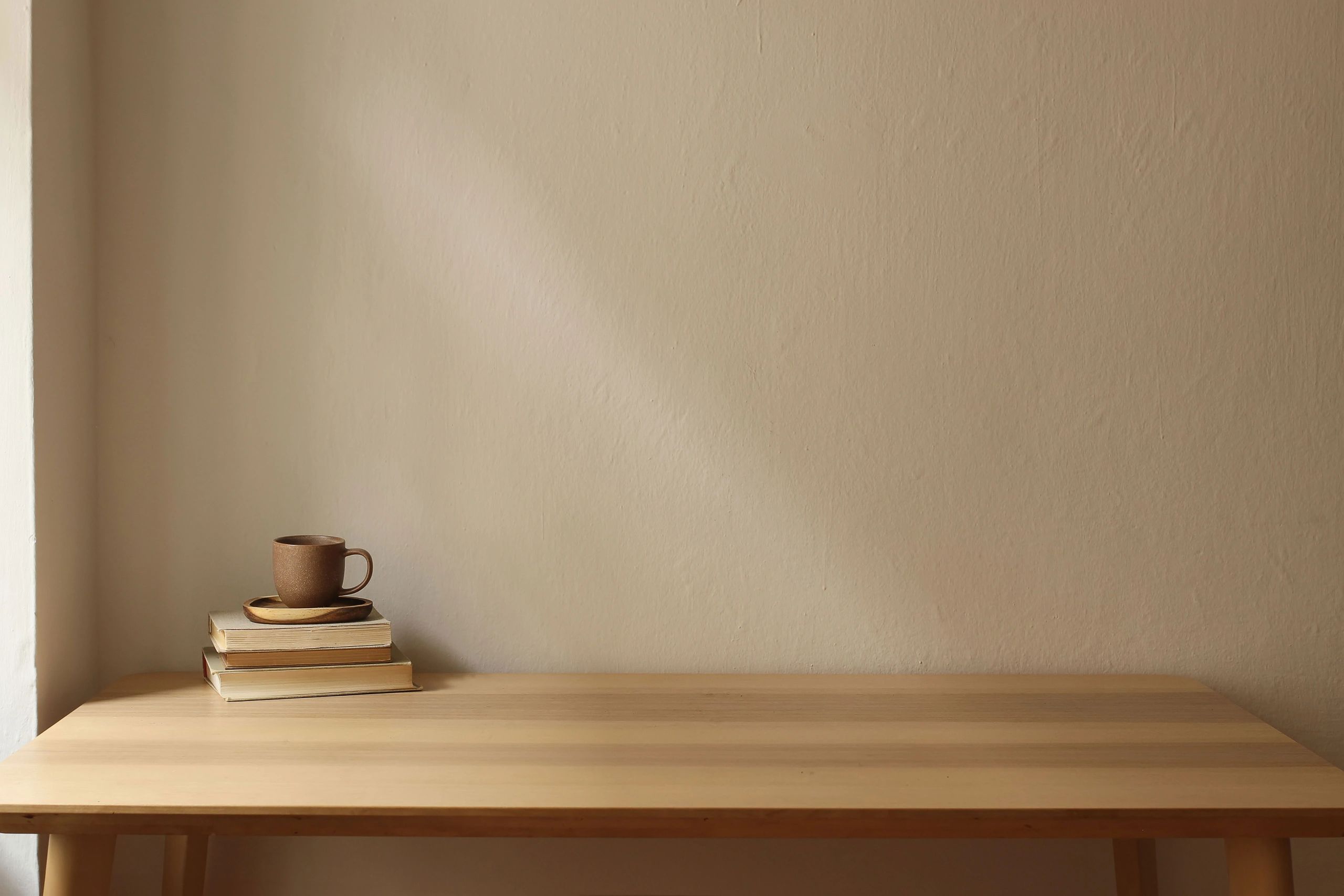 Stacked books and coffee on a wooden table
