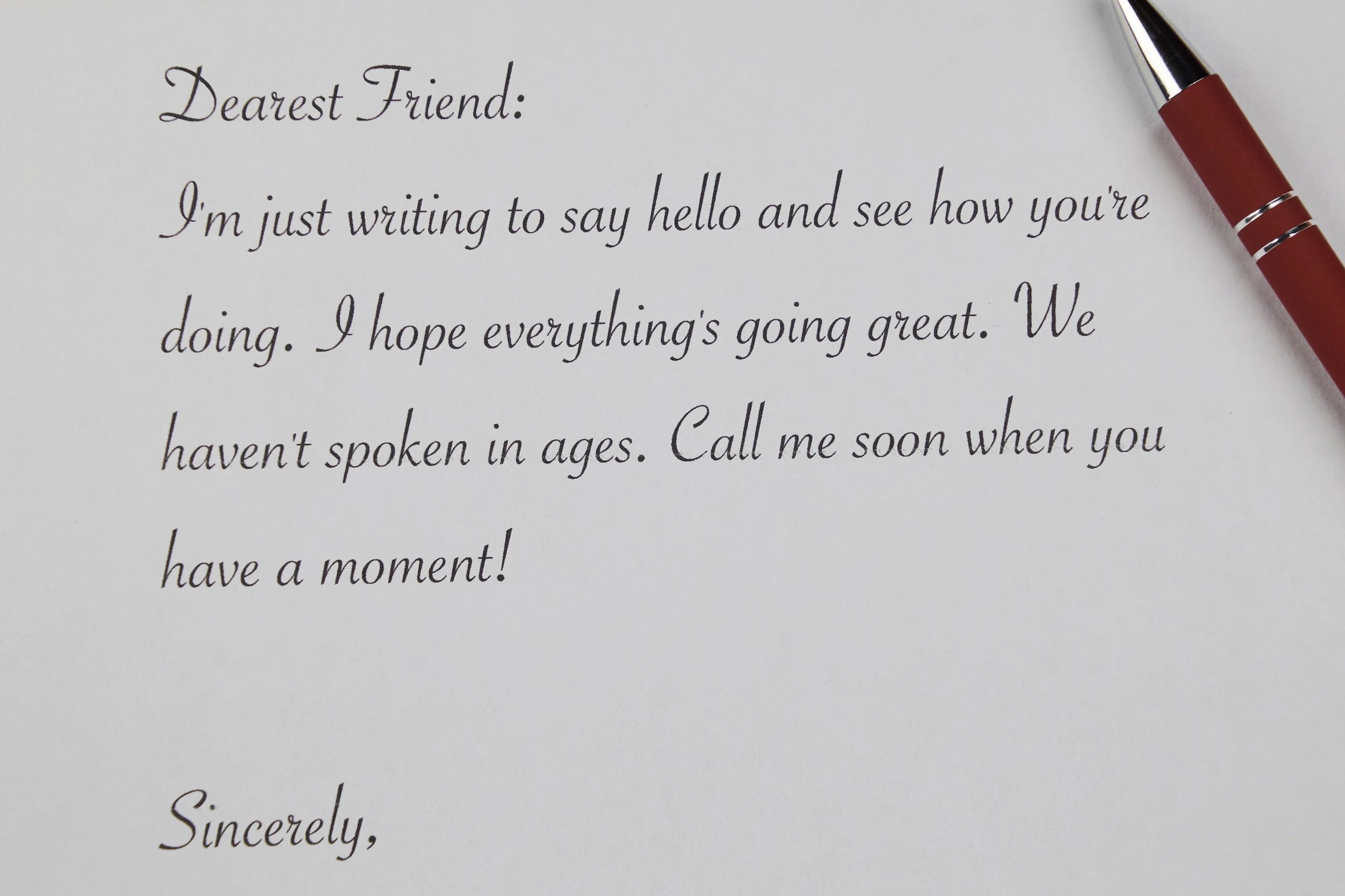 Handwritten letter with envelopes and pen on a desk