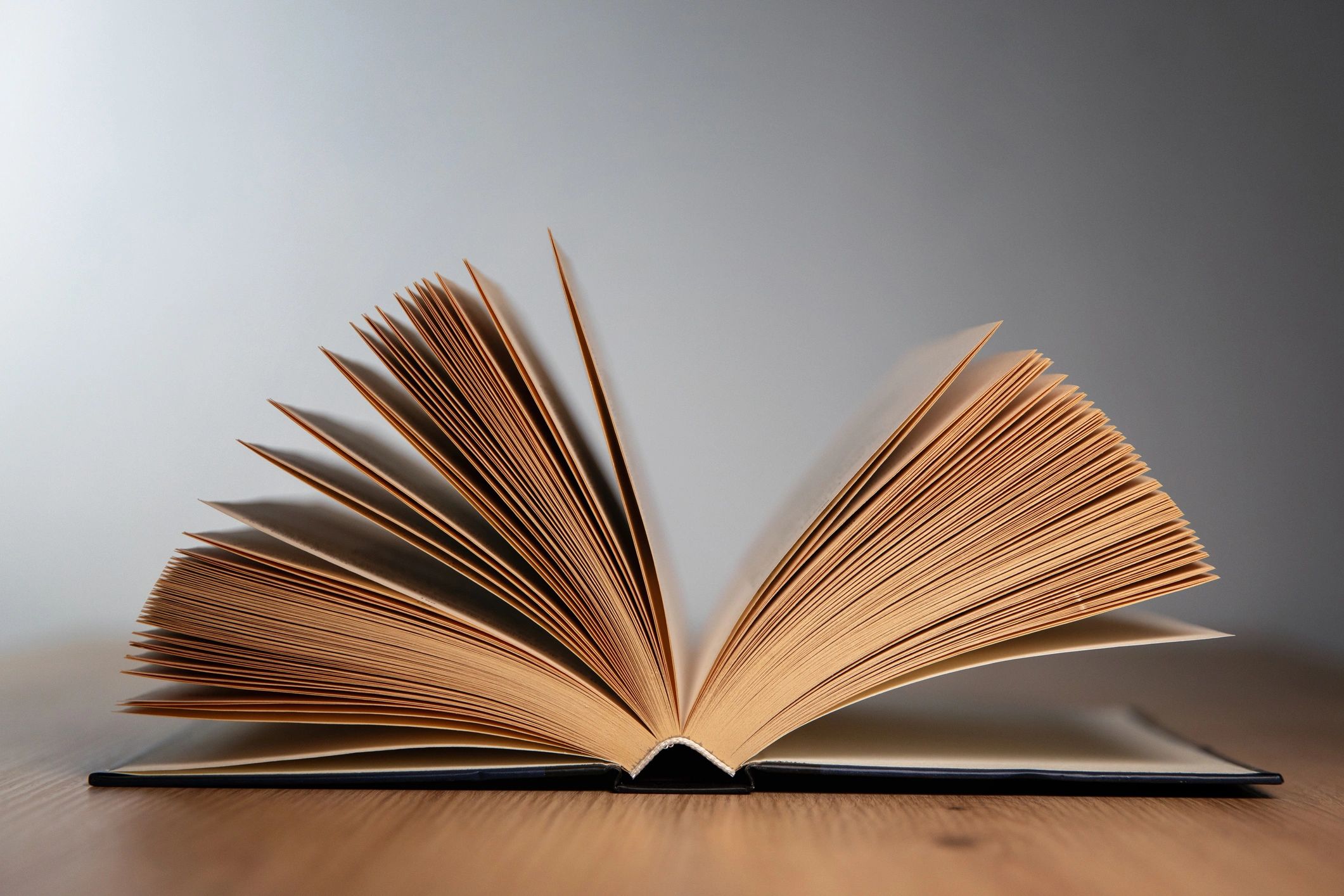 Open book on a wooden table in soft light